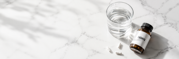 NMN supplement bottle with capsules on clean white surface — NMN and NAD+ guide