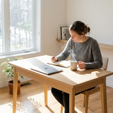 Focused person working at a bright desk with tea, representing the Energy & Focus Collection
