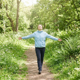 Healthy person walking outdoors in a green park, representing the Immune Support Collection